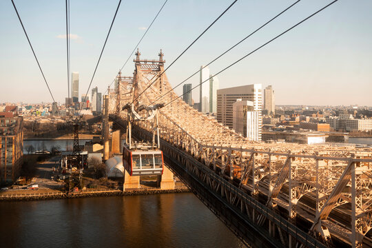 USA, New York, New York City, Overhead Cable Car moving along Queensboro Bridge at dusk