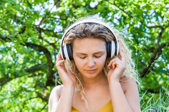 Young woman listening to music with closed eyes