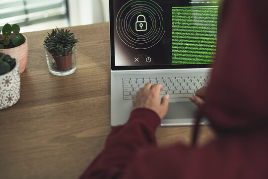 Woman accessing data lock on laptop at home