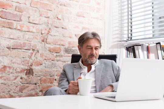 Businessman using laptop at desk