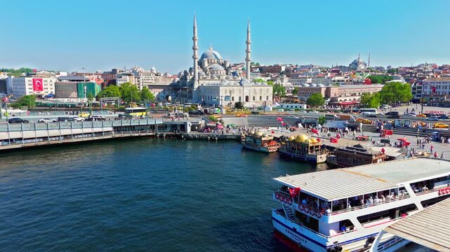 Aerial view of Galata Bridge and Yeni Mosque in Istanbul, Turkey. Ferries, waterfront roads and the busy Eminonu district surround the historic landmark.