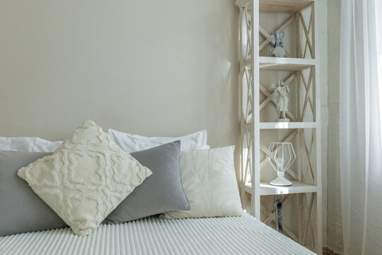 Cozy Bedroom Interior with Wooden Shelving and Pillows