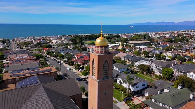 Aerial orbit around American Martyrs Catholic Church Bell Tower in Manhattan Beach, Los Angeles, California, USA