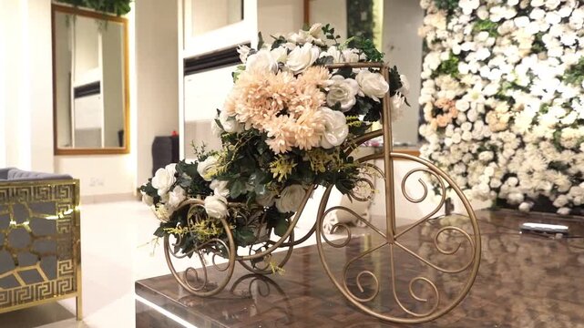Beautiful wedding stage setup featuring elegant white and yellow floral arrangements, decorative vintage-style bicycle stand, luxury seating, and stylish event d&eacute;cor. Professional indoor wedding venue
