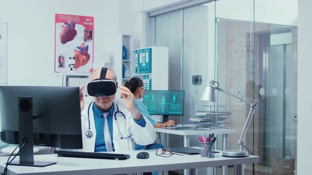 Senior physician uses VR glasses in a modern private clinic to study disease in virtual space while patients and doctors move in the hallway.