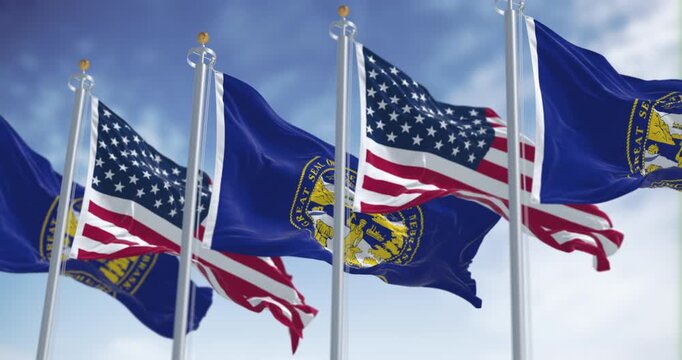 Nebraska state flags waving with the American flag