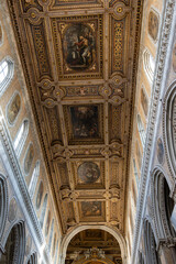 Obraz premium Naples, italy. December 27, 2024. Naples cathedral, or duomo di san gennaro, features a richly decorated baroque ceiling with paintings and golden stucco work