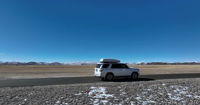 White offroad Car 4runner running a road trip on the high altitude trail in tibet, China