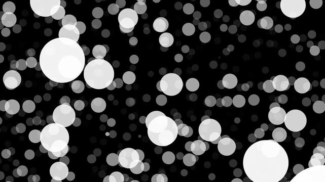 Black and white bokeh pattern featuring scattered circular dots of varying sizes, resembling falling snow or floating bubbles with a smooth glowing