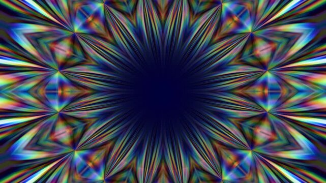 Rainbow colored kaleidoscope pattern with radiating spikes arranged in a circular symmetrical burst around a dark center with a smooth glowing today