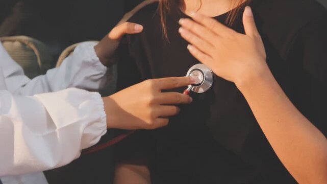 Doctor use stethoscope, checking up heart beat, auscultation in doctor office at hospital. Patient worker has to get medical checkup every year for her health