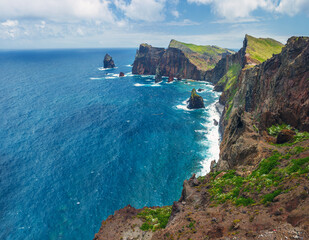 Majestic rocky cliffs of Ponta do Rosto meeting the deep blue waters of the Atlantic Ocean in São Lourenço peninsula, Madeira, Portugal. © volff