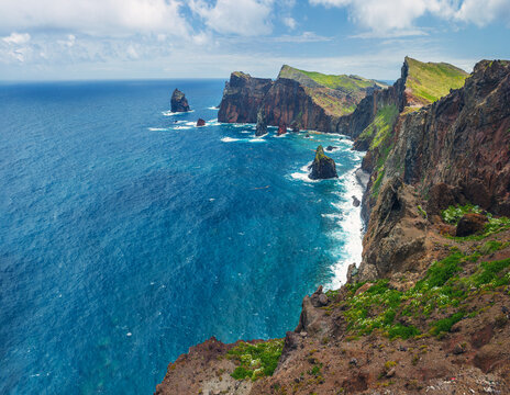 Majestic rocky cliffs of Ponta do Rosto meeting the deep blue waters of the Atlantic Ocean in S&atilde;o Louren&ccedil;o peninsula, Madeira, Portugal.