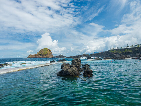 High-angle perspective of the circular natural volcanic swimming pool filled with ocean water on the coast of Porto Moniz, Madeira, Portugal. 10.04.2025