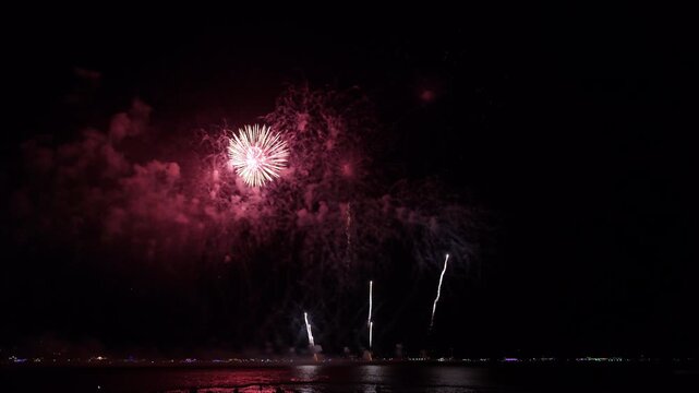 Colorful Fireworks Display Illuminating The Night Sky Over The Ocean Coastline In Pattaya Chon Buri Thailand