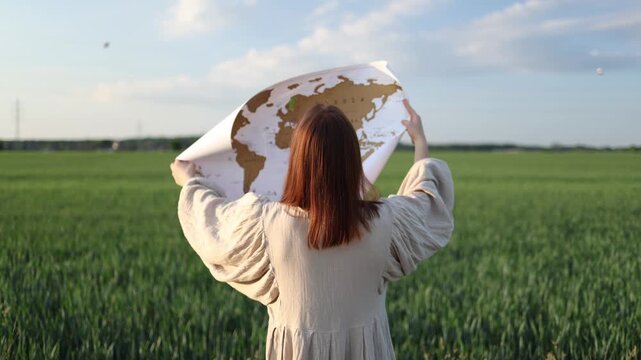Young woman holds a world map in silence grieving how war changes countries people and future wondering whether the world will ever be the same again
