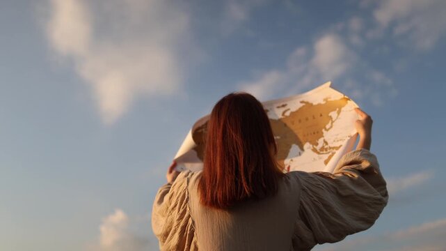 Young woman studies a world map searching for answers as climate change reshapes ecosystems threatens biodiversity and transforms the future of our planet
