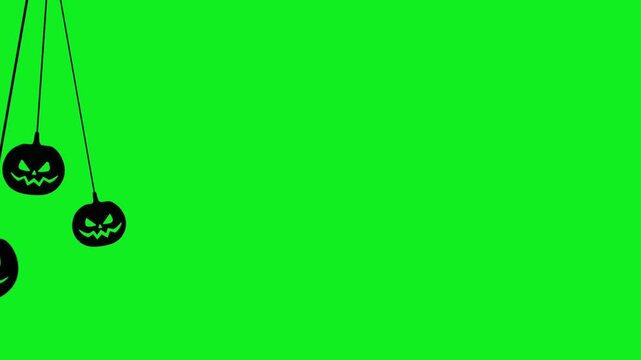 Seamless animated trio of hanging jack o lantern silhouettes with laughing faces on green chroma key background. Halloween overlays, spooky video editing, horror content, video element.