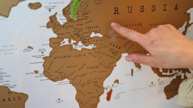 Finger pointing at Ukraine on a world map highlighting geopolitical awareness global conflicts humanitarian concerns and the importance of peace and international security