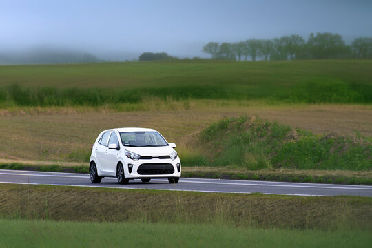 Modern hatchback driving on countryside road
