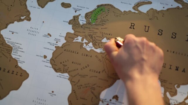 Hand holding a lighter over Ukraine on a world map symbolizing the constant risk of conflict escalation fragile peace geopolitical instability and global security concerns