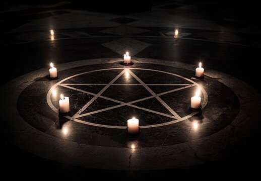 A dark scene showing candles lit around a pentagram on a patterned floor with low light