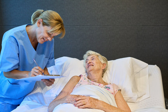 Nurse Caring for an Elderly Woman in a Rehabilitation Facility