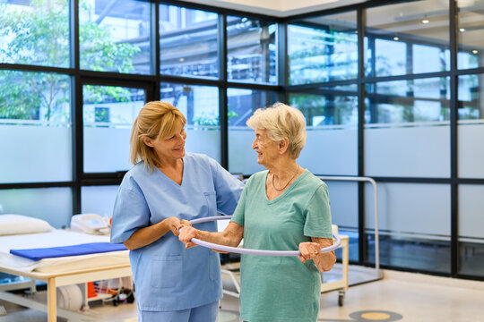Elderly Patient Engaged in Friendly Physical Therapy with a Healthcare Professional