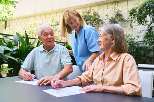 Seniors Enjoying Activities with a Caregiver in a Rehabilitation Facility