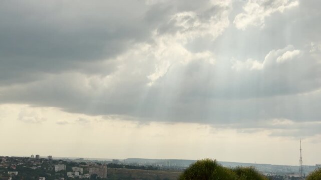 Bright sunbeams break through dark clouds over the city of Simferopol, Crimea. This beautiful sight brings a hopeful feeling of awe and peace.