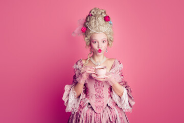 Fototapeta premium Photo of gorgeous pretty lady dressed pompous rococo costume enjoying tea empty space isolated pink color background