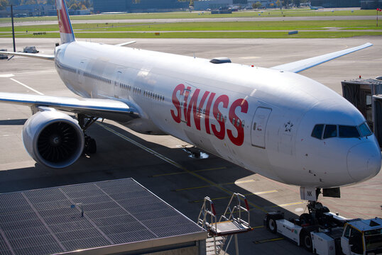 Swiss passenger airplane type Boeing 777-300ER HB-JNK ready for pushback at Swiss Z&uuml;rich Airport on a sunny autumn day. Photo taken October 18th, 2025, Zurich Airport, Switzerland.