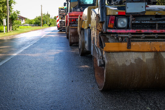 Road Rollers Compacting Fresh Asphalt During Active Highway Construction Project