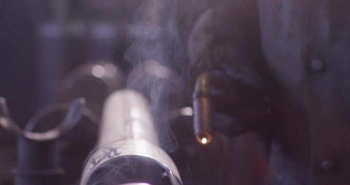 Close up of an arc welder creating sparks while joining a metal pipe
