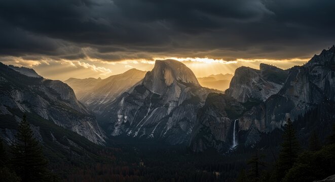 Dramatic sunset over majestic mountains with rugged landscape and cloudy sky