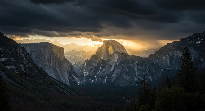 Sunset view of majestic mountains with Half Dome peak rising above trees under dramatic stormy sky in scenic valley