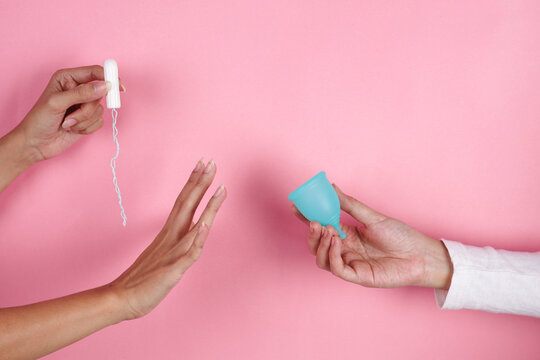 Hand Holding Menstrual Cup Is Chosen Over Disposable Tampon