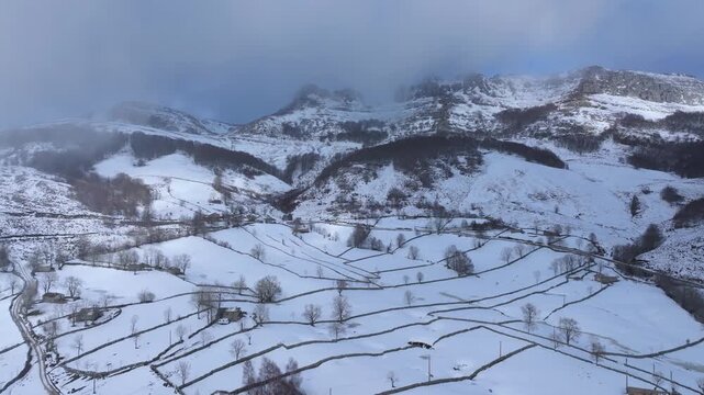 Aerial drone view of the winter landscape of hay meadows and traditional Pasiego cabins in the Burgos Mountains. Las Machorras, Pasiego Valleys, Merindades, Burgos, Castile and Le&oacute;n, Spain, Europe