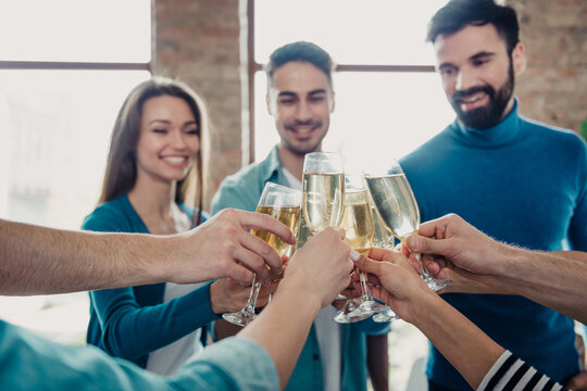 Colleagues toasting with champagne in a bright modern office celebrating team success and friendship