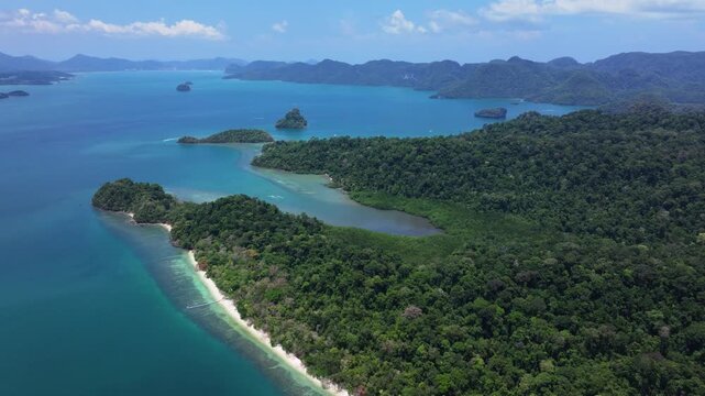 4K slow motion drone footage capturing the lush green landscapes of Pulau Singa Besar and the surrounding Langkawi islands in Malaysia.