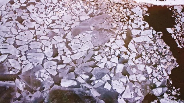Overhead drone footage of beautiful frozen Great Lakes ice patterns in a tranquil winter setting.