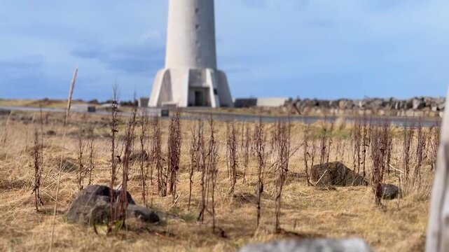 Scenic footage of the iconic Akranes Lighthouse overlooking Iceland's rugged coastline with dramatic ocean views, making it perfect for travel, tourism, nature, and cinematic productions.