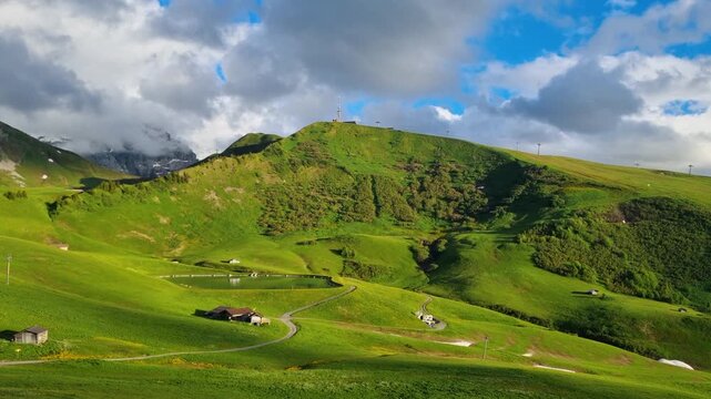 A stunning summer view over Brenggen See near Metschstand above Lenk, Switzerland, where sunlit green meadows, alpine landscapes and rugged mountain peaks create a spectacular hiking paradise