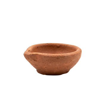 A terracotta diya oil lamp with a textured surface presented on transparent background clay traditional indian