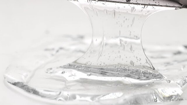 A close-up front view of a transparent stretchy cosmetic gel. Beauty product, soap, and shampoo.