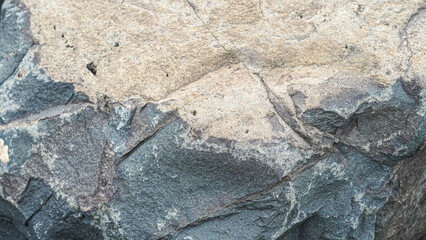 Fototapeta premium Weathered granite stone with dual textures, contrasting gray and beige surfaces