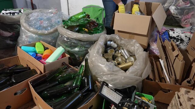 Recycling Sorting Center. Waste sorting belt. Hand separation of waste and the recovery of recyclable materials