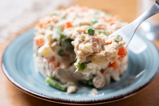 Russian Salad on a Fork on wooden table