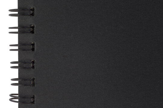 black cover of sketchbook with spiral binder against white