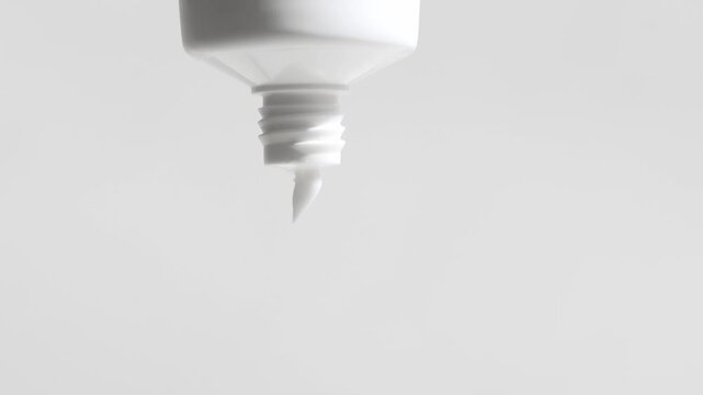 Cosmetic lotion, cream in packaging slowly flows out, front view, neutral light background.